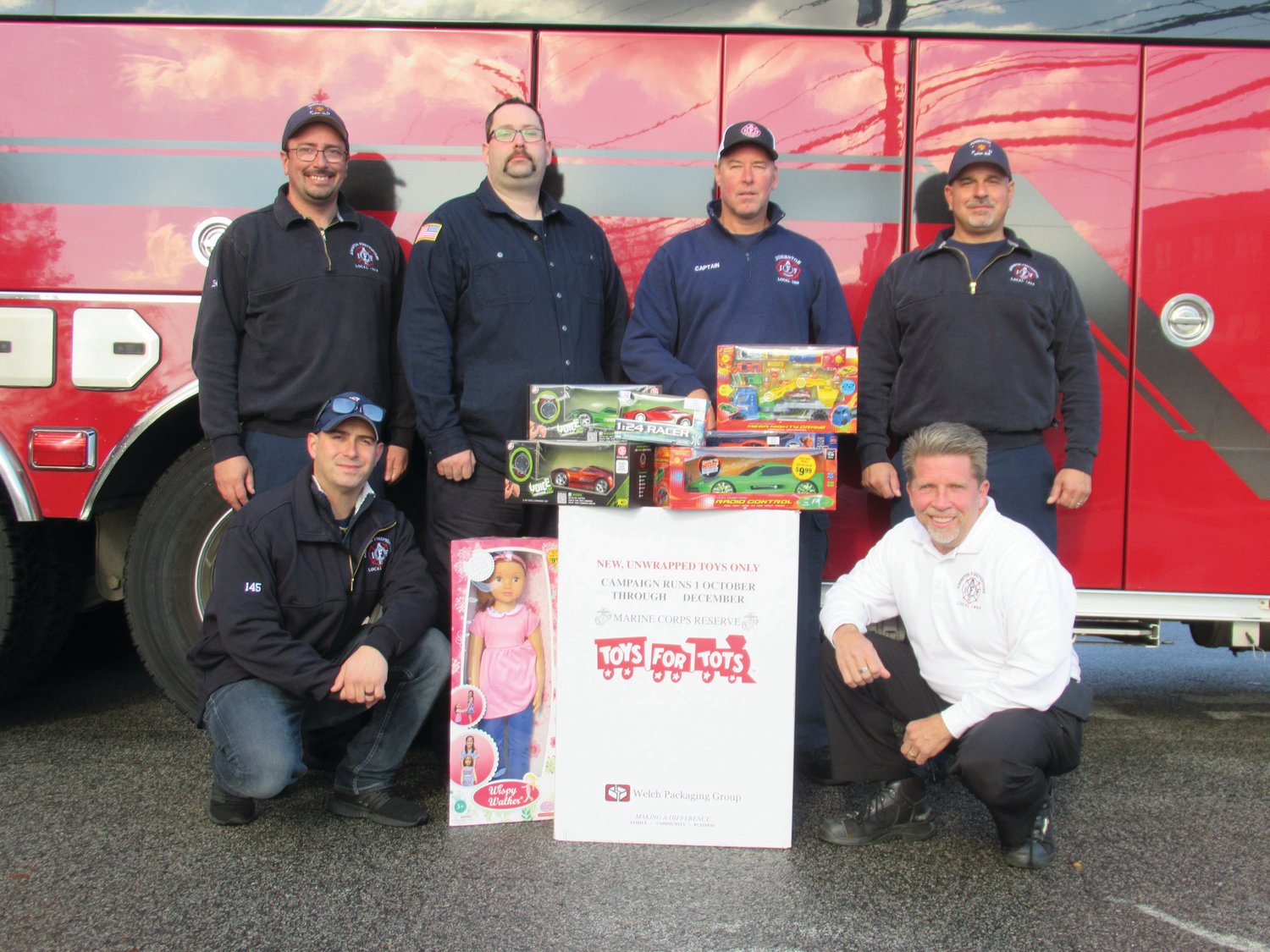 TOY TROOP: Among the Johnston Fire Department firefighters taking part in the annual Toys for Toys Drive are, in front from left: Chris DelFino and Richard Boehm. Top: Scott Thacker, Kevin Hoskins, Bob Marshall and Paul Pontarelli.